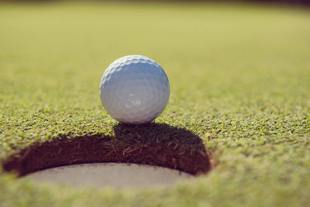golf ball in the hole - Foto, imagen