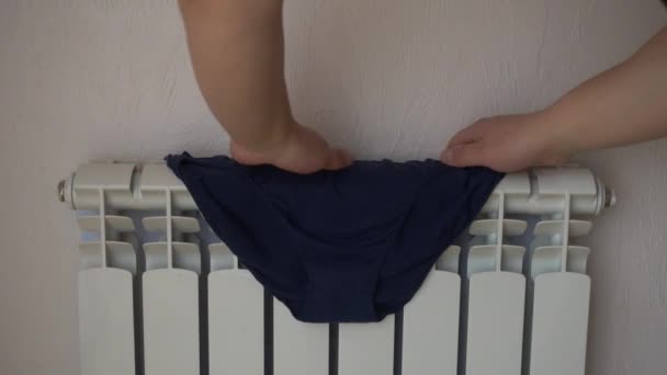 Heating radiator. Swimming trunks, drying after washing. - Footage, Video