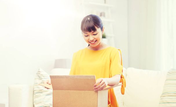 happy asian young woman with parcel box at home - Fotoğraf, Görsel