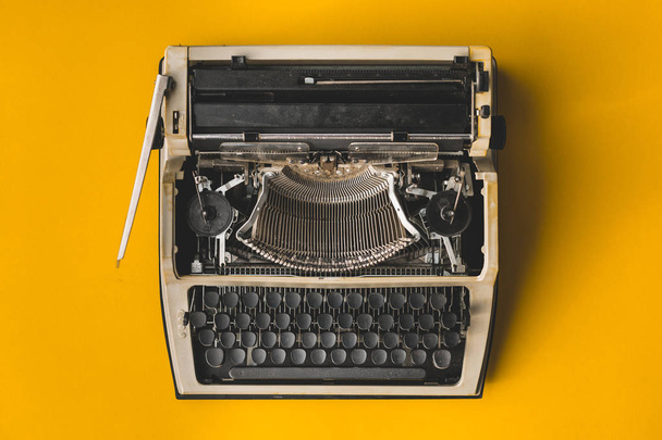 Old Retro Typewriter On A Yellow Background, Top View. Creative  - Photo, Image