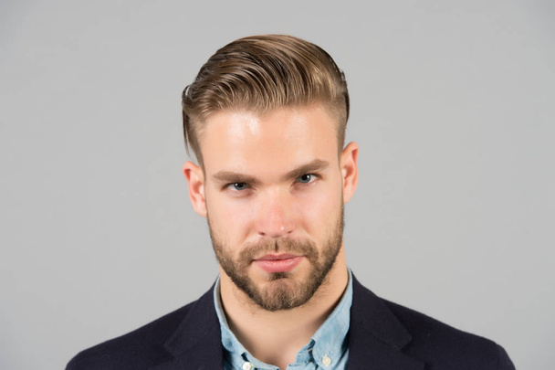 Businessman with beard and mustache on unshaven face. Bearded man with stylish hair or haircut. Beard grooming and hair care in barbershop. Business fashion style and trend concept - Фото, изображение