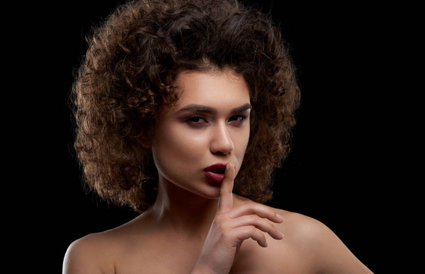 Charismatic curly model posing on black background. - Foto, imagen