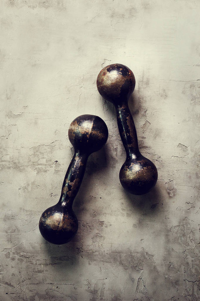 Old dumbbells on concrete background. Sport concept. Free space for your text. - Фото, изображение