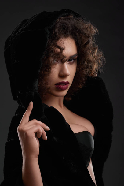 Passionate curly girl posing in black jacket. - Foto, Imagem