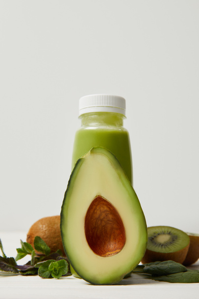 green smoothie with fresh avocado, kiwi and mint on wooden surface    - Foto, immagini