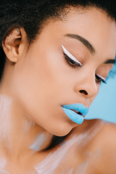 close-up portrait of young woman with creative makeup and perfect skin on blue - Foto, imagen