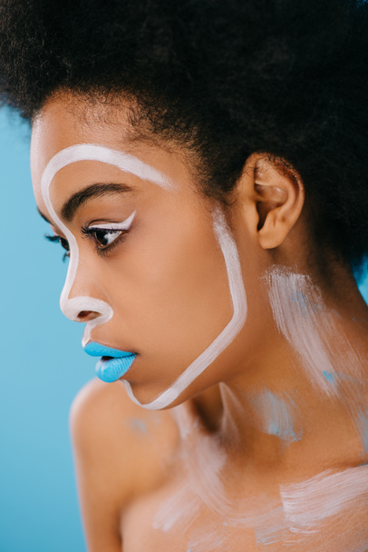 close-up portrait of beautiful young woman with creative makeup isolated on blue - 写真・画像