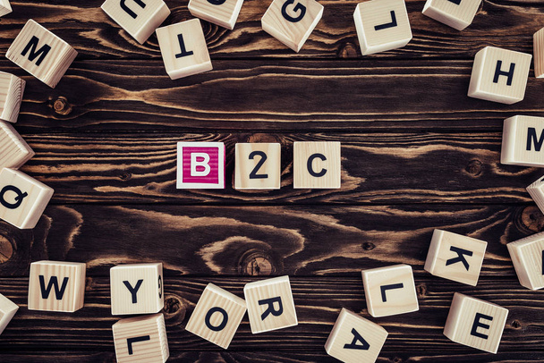 flat lay with b2c inscription made of wooden blocks on brown wooden tabletop - Fotografie, Obrázek