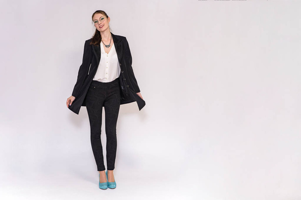 beautiful girl in business suit on white background in different poses - Foto, afbeelding