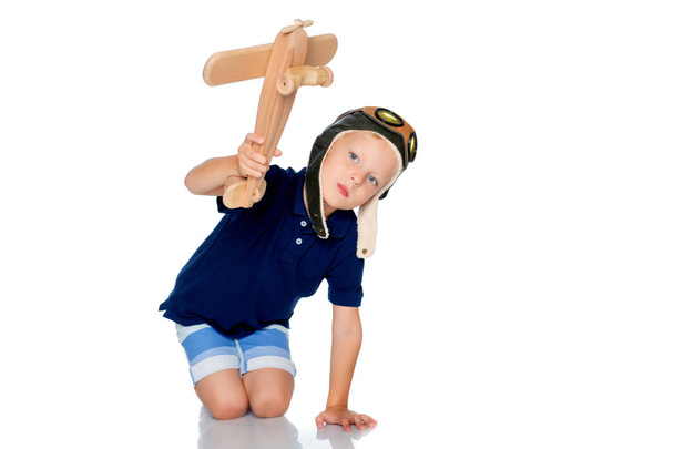 Little boy with a wooden plane. - Photo, Image