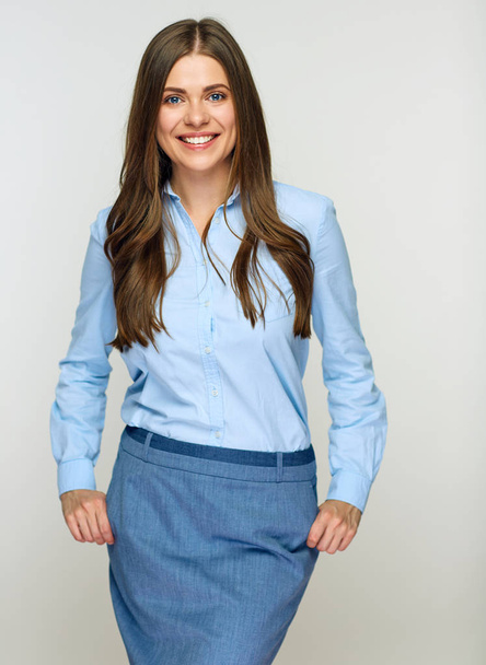 smiling successful businesswoman in blue shirt and grey skirt posing isolated on white background - Foto, Bild
