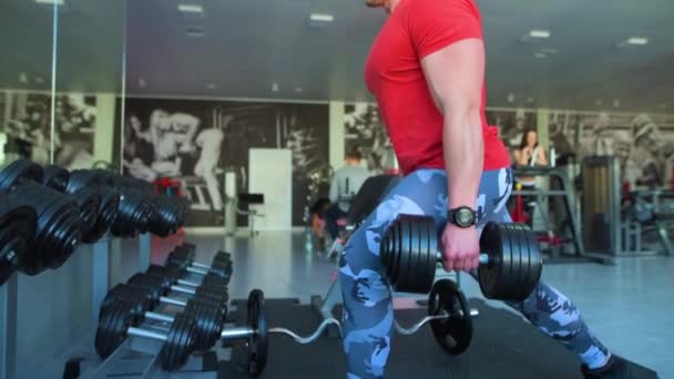sport, bodybuilding, lifestyle, technology and people concept - young man with smartphone in gym - Footage, Video