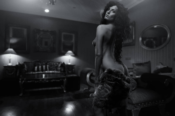 Gorgeous naked brunette posing indoors - 写真・画像