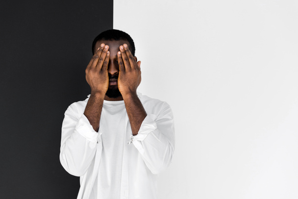 stylish african american man in white clothes closing eyes with hands - Foto, immagini