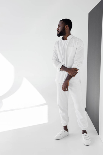 handsome african american man in white trendy clothes looking away  - Fotografie, Obrázek