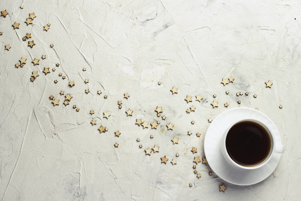 Cup of coffee and stars on a light stone background. Flat lay, t - Zdjęcie, obraz