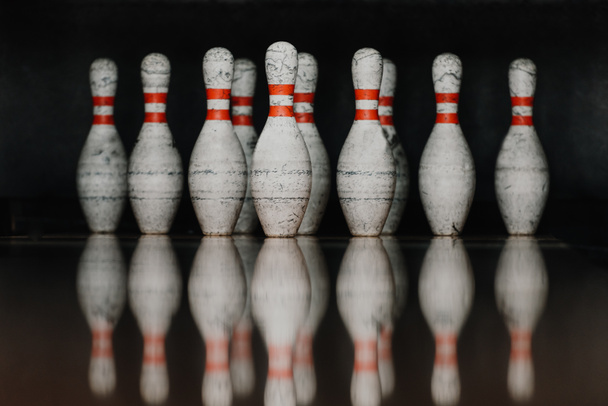 grungy bowling pins in gate with reflection in polished floor - Фото, изображение