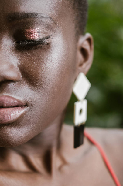 halved portrait of attractive african american woman with glitter makeup   - Fotografie, Obrázek