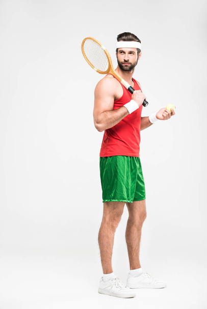 sportive tennis player posing with retro wooden racket and ball, isolated on white   - 写真・画像