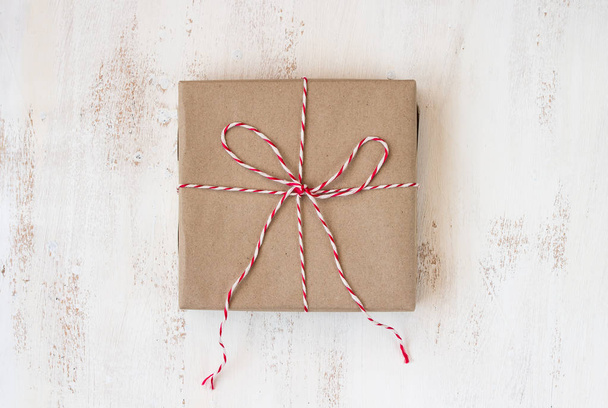 vintage gift box handmade with red rope on white wooden board - Фото, изображение