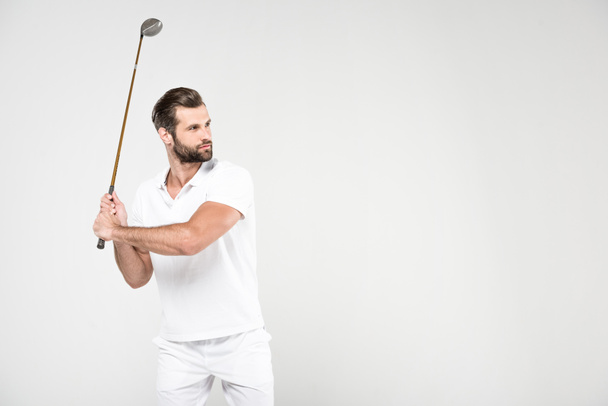 confused golf player in white sportswear with golf club, isolated on grey - Zdjęcie, obraz