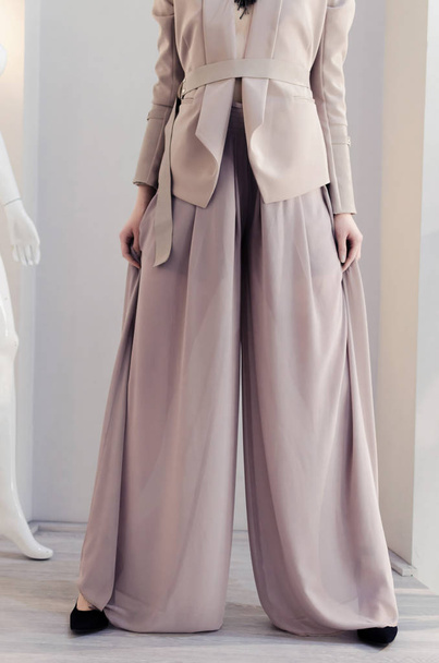 Fashionable woman posing in business jacket and wide-leg pants - Zdjęcie, obraz