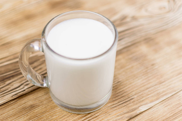 Glass kefir (milk) on a wooden background. The concept of diet, weight loss. - Photo, image