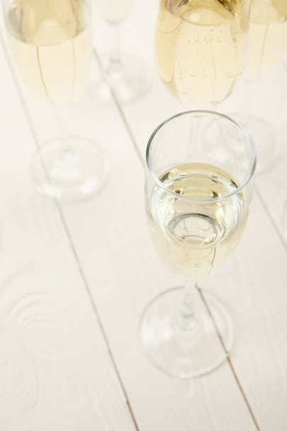 high angle view of champagne glasses on white wooden table  - Valokuva, kuva