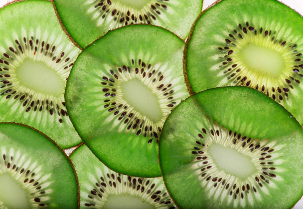 Bright fresh kiwi slices, back light transparent fruit. - 写真・画像
