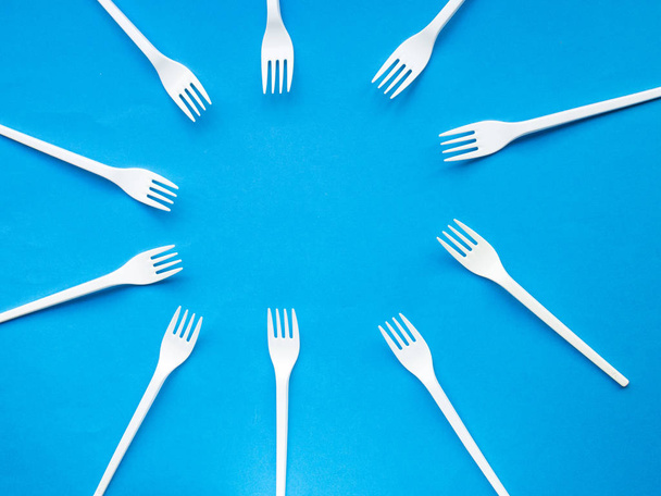Plastic fork pattern on blue background - Photo, Image