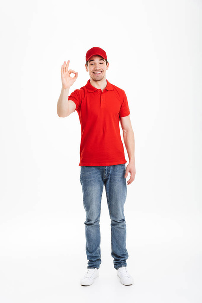 Smiling young delivery man with okay gesture - Fotografie, Obrázek