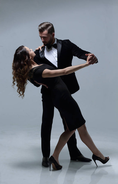 Attractive young couple dancing in studio. - Photo, image