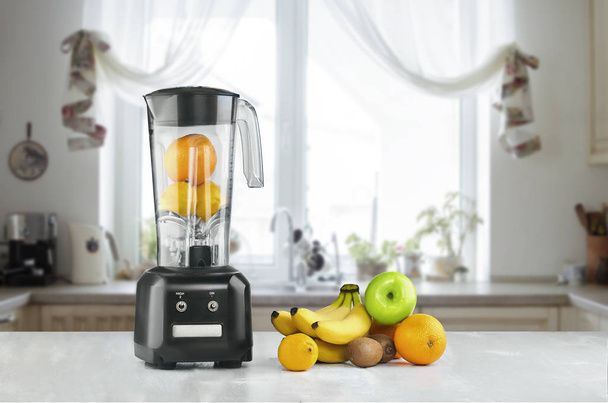 Blender and fruits on kitchen space - Photo, Image
