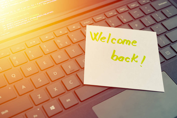 Welcome back message concept written post it on laptop keyboard - Photo, Image