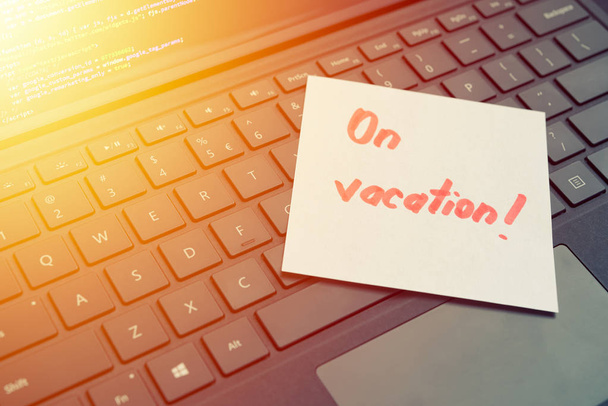 On vacantion message concept written post it on laptop keyboard - Photo, Image