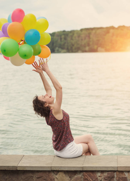 girl with colorful balloons outdoor - Photo, Image