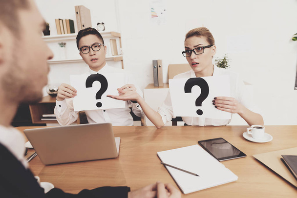 HR director woman in blouse and skirt working in office with coworker holding question marks at job interview  - 写真・画像