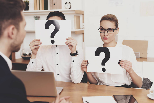 HR director woman in blouse and skirt working in office with coworker holding question marks at job interview  - Foto, afbeelding