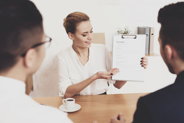 HR director woman in blouse and skirt showing resume at job interview - Photo, image
