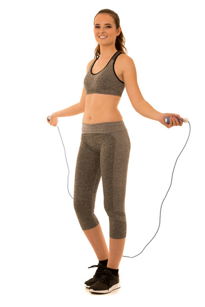 Beautiful young fit woman works out with speed rope isolated ove - Foto, imagen