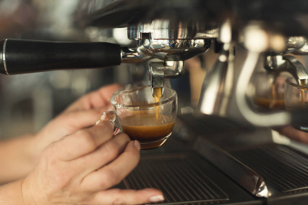 Closeup of barmen hand brewing espresso in professional coffee machine - Foto, Imagem