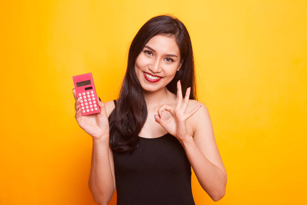 Asian woman show OK with calculator. - Фото, зображення