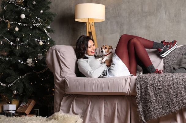 Lady lying on the sofa with a puppy. Photographie retouchee - Фото, зображення