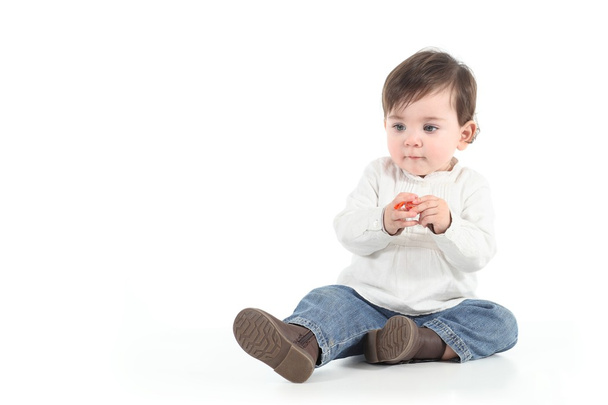 Baby with a candy in her hands - Foto, Bild