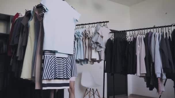 Woman posing in new dress in showroom - Filmati, video