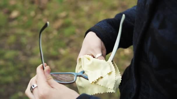 Žena ruce čištění brýlí s měkký hadřík z mikrovlákna. - Záběry, video