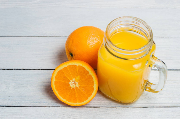 Sliced Orange and Juice Drink on White Wooden Background. Healthy Concept. - Foto, Imagem