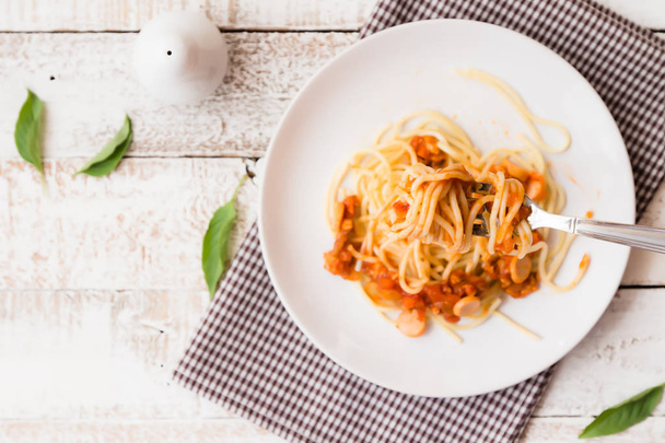 delicious homemade plate of spaghetti on white wooden board. top view - Photo, Image