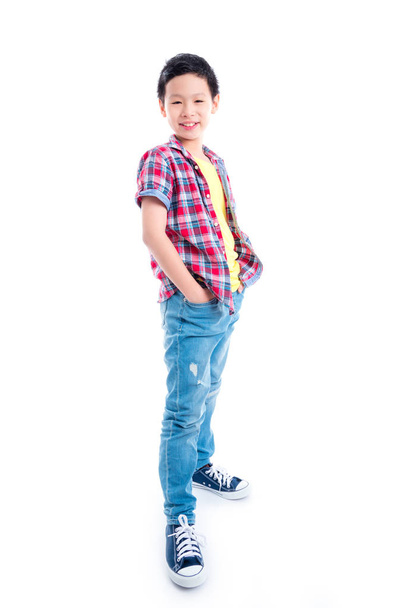 Full length of young asian boy standing over white background - Photo, image
