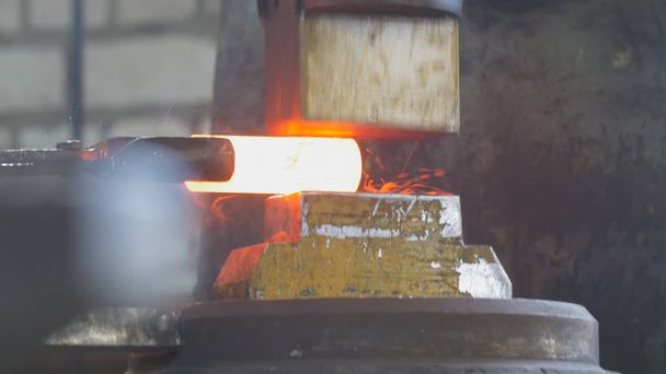 Blacksmith with hammer in forge creating steel knife - Photo, Image